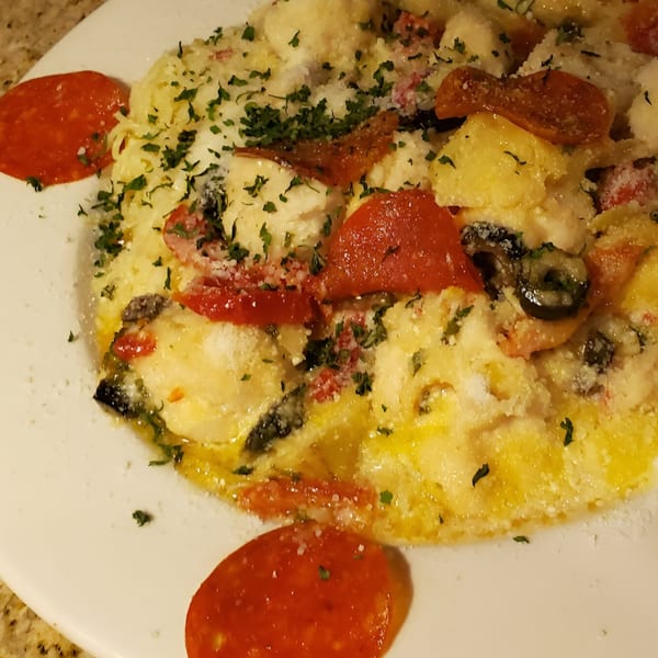 Windham Restaurant's pasta dish with pepperoni, olives, and herbs, topped with grated cheese.